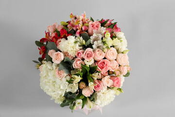 Bouquet of beautiful flowers on grey background, top view