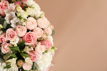 Bouquet of beautiful flowers on beige background, top view. Space for text