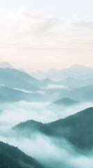 Fototapeta premium Misty morning mountains with soft clouds and a pastel gradient sky create a dreamy atmosphere for a phone background wallpaper