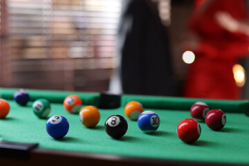 Many colorful billiard balls on green table indoors, closeup. Space for text