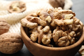 Fresh ripe walnuts in bowl on table, closeup