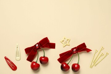 Cute hair accessories on beige background, flat lay. Space for text