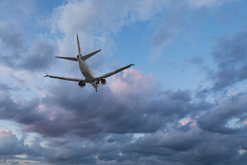 Airplane flying in beautiful blue sky with clouds