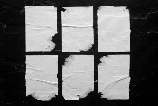 Set of white torn posters on black background.