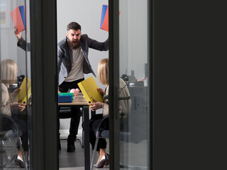 Angry boss shouting at an employee. Office conflict. Frustrated secretary dealing with a rude boss. Nervous employee facing an angry manager. Boss screaming in frustration. Office conflict.