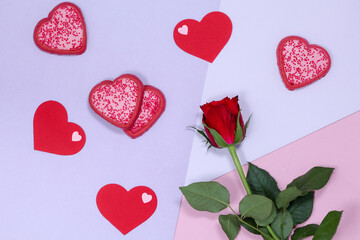 Heart-shaped cookies and a red rose on the right side.