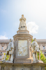 The monument honors Leonardo da Vinci, surrounded by figures representing his contributions to art...
