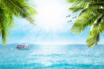 Blurred sea indigo and blue sky with bokeh sun light, Leaves of coconut trees, fishing boat and seagulls in picture. Travel style summer landscape blur background pattern.