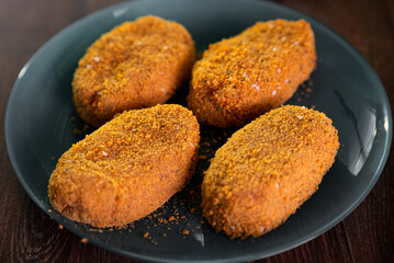 Paning cutlets on a blue plate