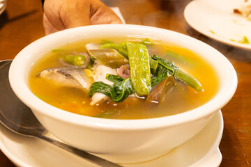 filipino fish soup in white bowl 