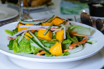 Mango salad on white plate 