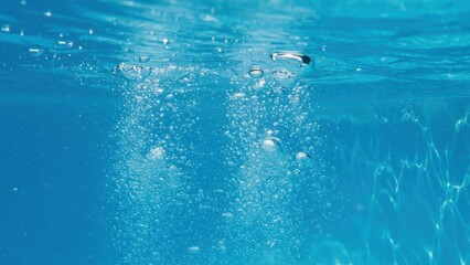 Naklejka premium Underwater scene showcasing bubbles in clear blue water.