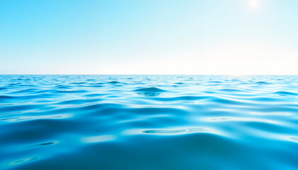 Tranquil ocean waves gently rippling under clear blue sky, serenity