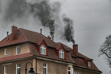 Smoke from the chimney. Winter heating with coal and air pollution