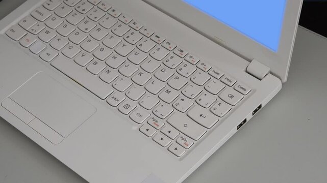 Mini white laptop with AZERTY keyboard. Close-up view