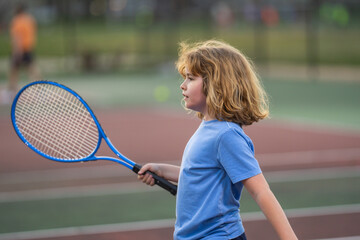 The Tennis. Kid with tennis racket and tennis ball playing on tennis court.