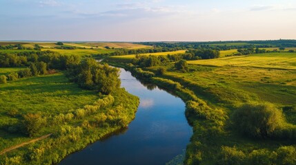 Obraz premium The countryside of Ukraine is beautiful in the summer. The small Sura River flows through the fields, making the perfect backdrop for a relaxing day in nature.