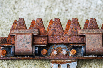 rusted mechanical blade with sharp teeth detail.