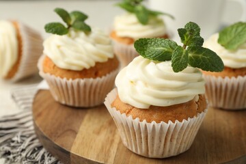 Delicious carrot cupcakes with mint on table, closeup