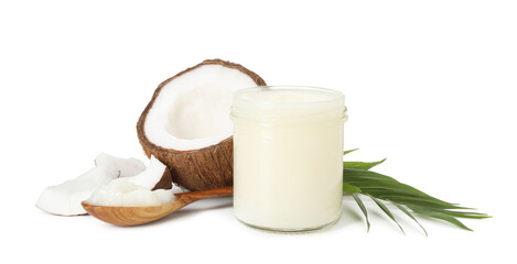 Cooking oil in glass jar, pieces of coconut, green branch and spoon isolated on white