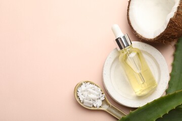 Hair treatment. Cosmetic product, coconut, butter shavings and aloe leaves on beige background,...