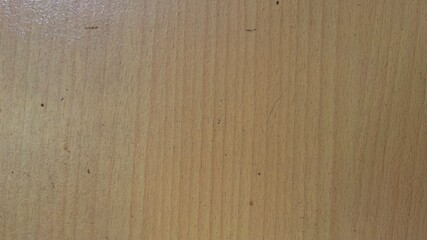 The wooden surface looks smooth and even. The wooden surface has a warm light brown color with a clearly visible wood grain pattern
