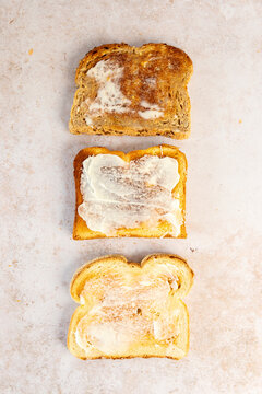 Three different types of bread toasted with butter 