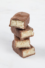Candy bar with coconut pulp, in milk chocolate. White background. 