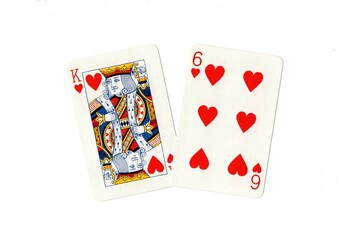 A king of hearts and one other card on a white background.