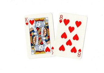 A king of hearts and one other card on a white background.