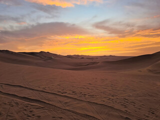 Colorful sunset over the desert sand dunes of Huacachina, Peru.