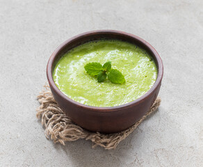 Pea mint soup puree. In a bowl. Rustic style. 