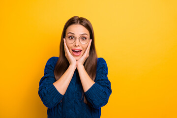 Portrait of cheerful girl screaming unbelievable touching her cheeks wearing maroon pullover...