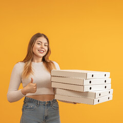 Happy woman with a thumbs up and stack of pizza boxes