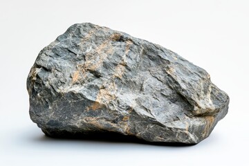 Obraz premium Natural Rock Formation on Simple Background - A large, textured rock is displayed against a light background, showcasing its natural features and colors