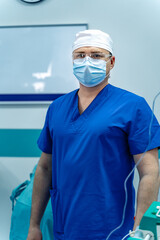 Doctor in scrubs preparing for surgery. A medical professional stands confidently in a surgical...