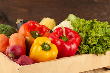 Fresh vegetables overflowing from wooden crate: vibrant still life