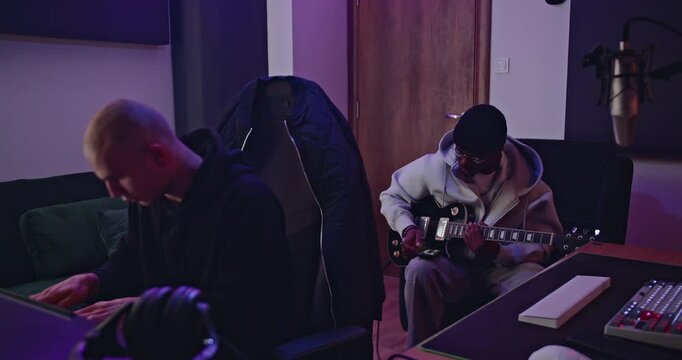 Music recording session in professional studio. Collaboration, creativity, and passion.