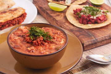 Mexican chorizo and bean soup with tacos and quesadillas in the background