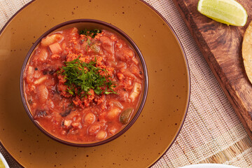 Delicious mexican poblano bean soup with chorizo and fresh herbs