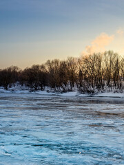 Snowy landscape with a river and trees