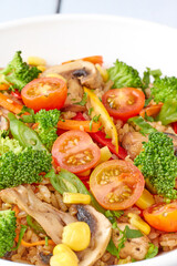 Delicious brown rice dish with sauteed vegetables filling a bowl