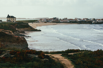 Coastal village and sandy beach in Baleal, Portugal, with ocean waves