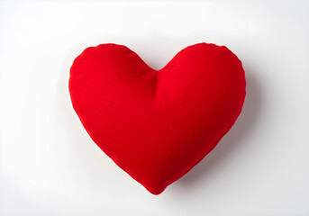 Soft red heart shaped pillow on a white background, perfect for expressing love, romance, and comfort in any setting.