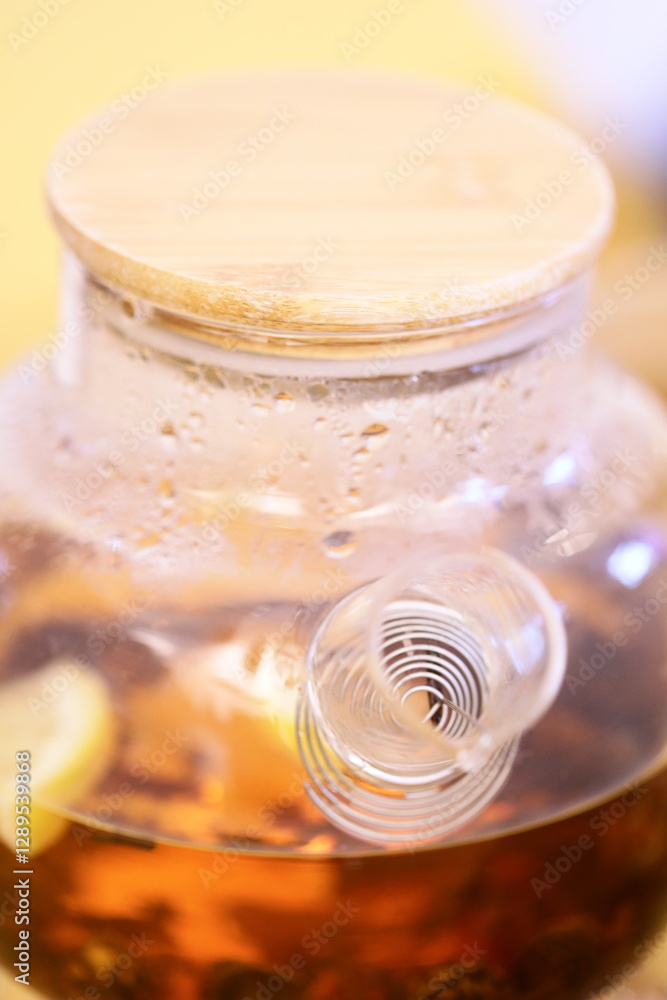 Poster a close-up shot of a bottle filled with liquid and accompanied by sliced lemons.
