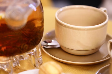 A classic tea set with teapot and saucer, perfect for warm beverage and intimate moments.