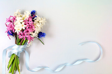 Bouquet with beautiful spring flowers hyacinths and muscari in vase on light background, banner,Abstract floral arrangement, still life with space for text, floral holiday card, 