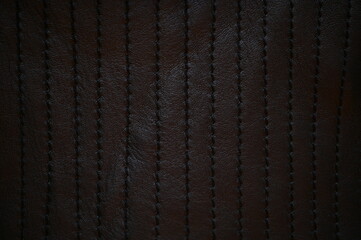 black leather texture close-up, seams on leather jacket as background, black natural leather as...