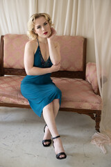 Beautiful blonde pinup girl, glamorous woman, American model in classy green dress