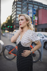 Beautiful blonde girl in the city, pinup girl, vintage style, classic beauty